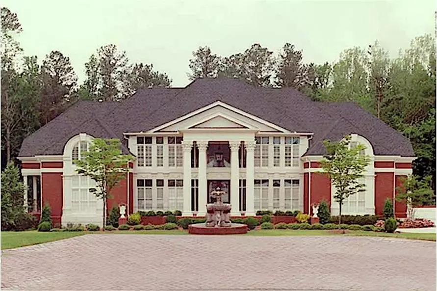 2-story, 5-bedroom Colonial style home with pediment atop the full-height double portico supported by tall columns