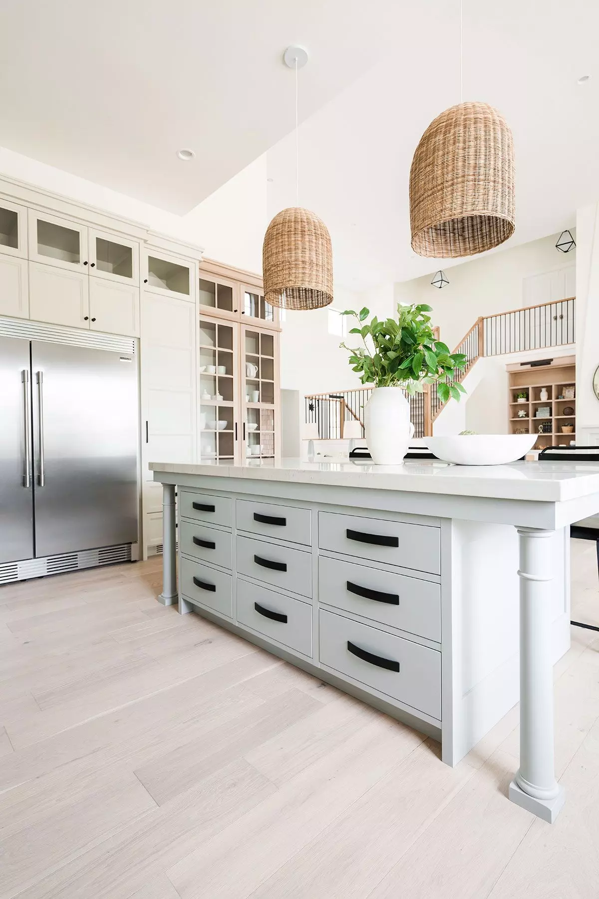 A light blue kitchen island with 4 stools