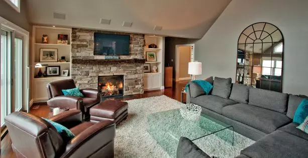 grey and brown living room with suede couches and upholstered table