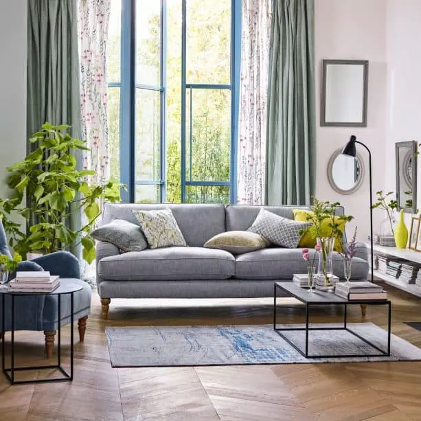 grey and brown living room with green patterned pillows