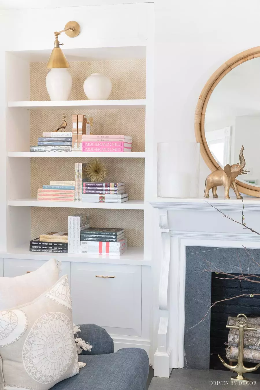 Gorgeous grasscloth wallpaper on the back of the bookcase adds so much to this space!