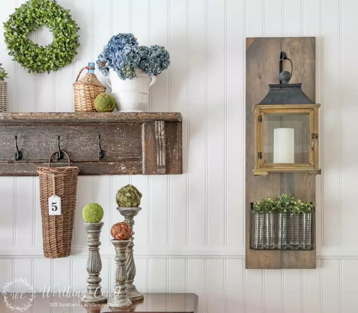 White paneled wall with hanging lantern and vintage shelf display.