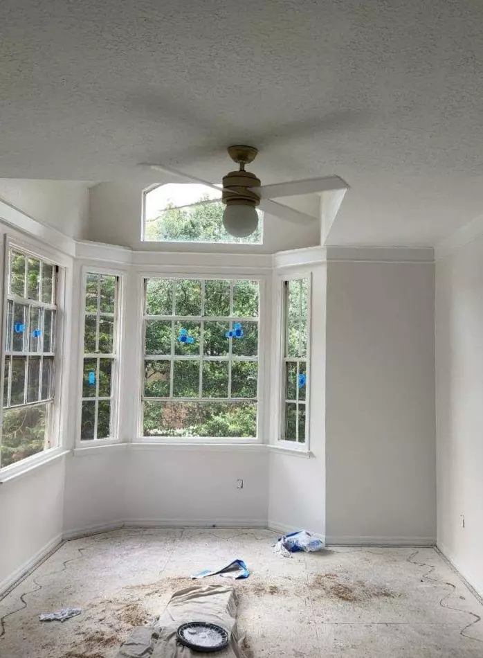 Large room with terra cotta tile flooring, fireplace and off-white warm paint color on walls, Sherwin Williams Snowbound