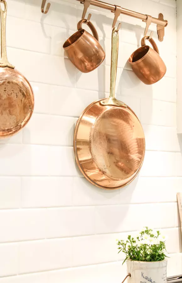 Copper pot rack for over a stove