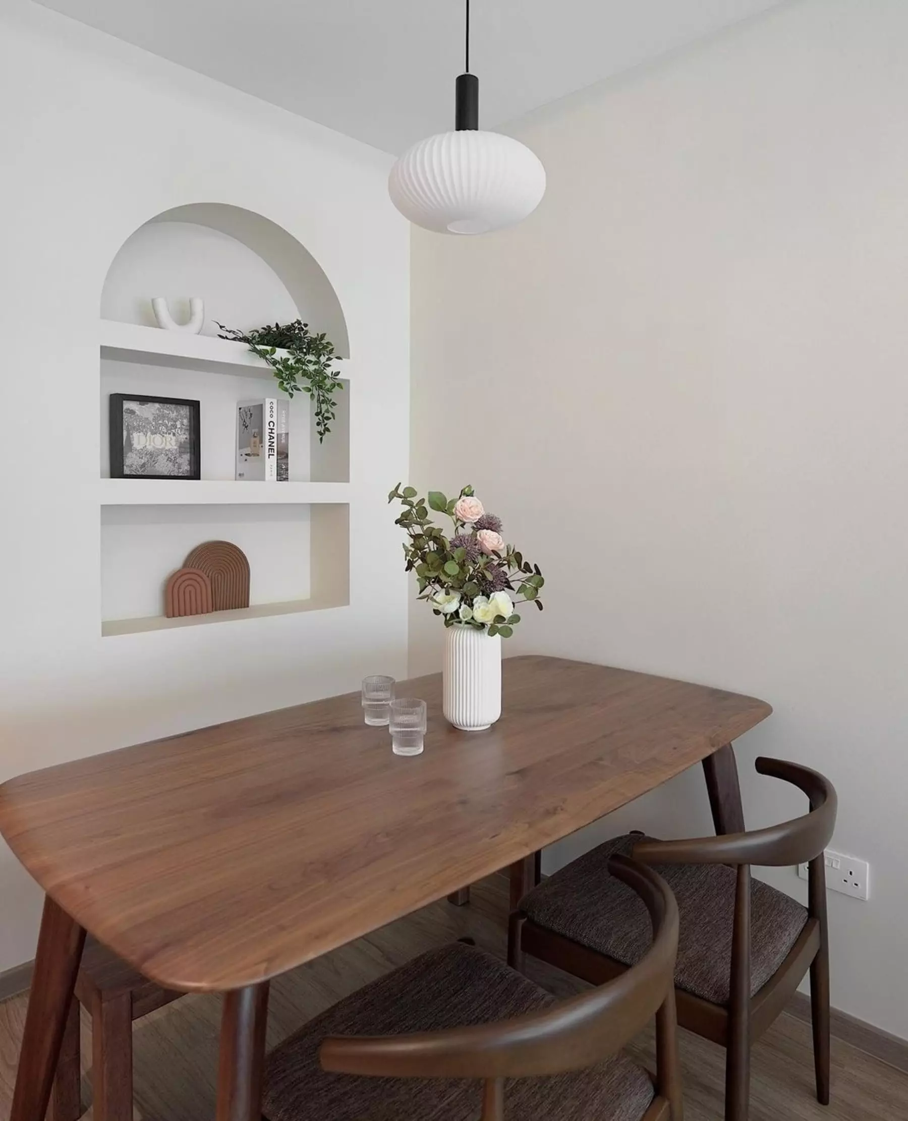 A wooden dining table with 2 matching chairs and a bench sits in a dining area.