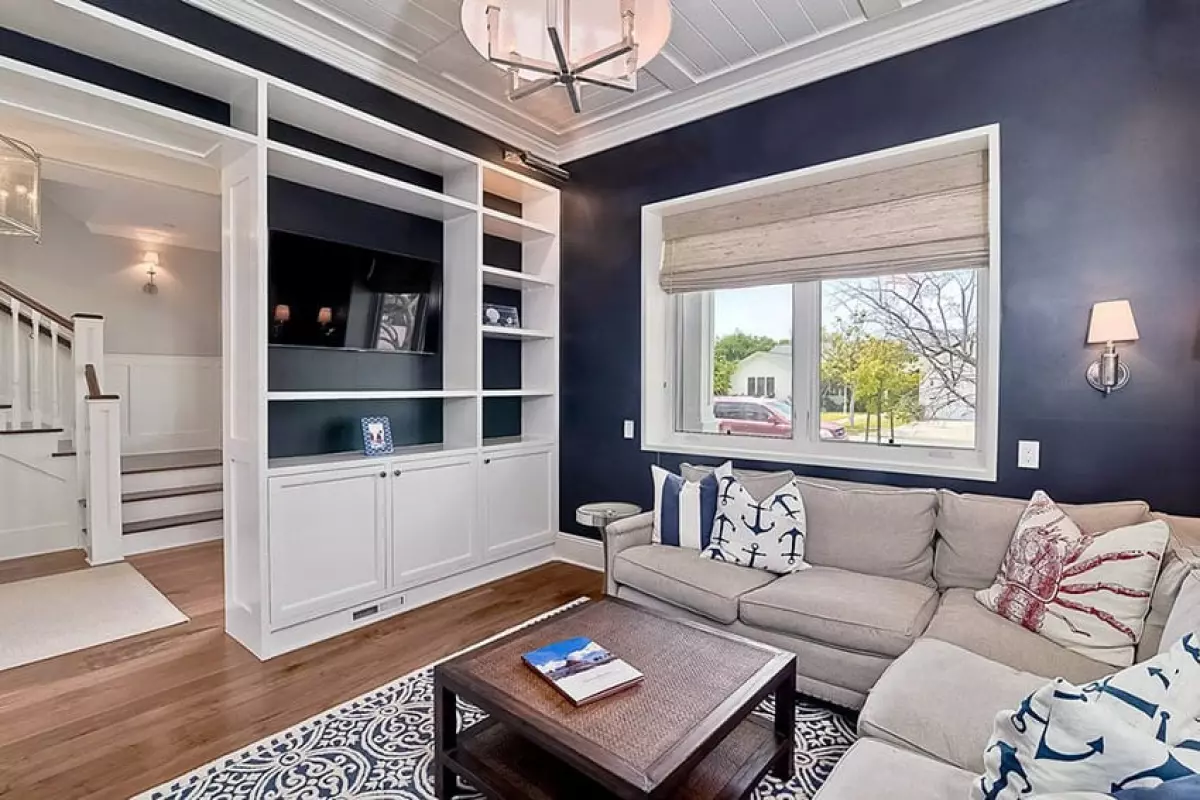 Traditional living room with dark walls and white built-in bookshelf