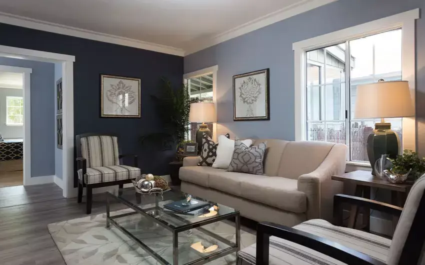 Contemporary living room with blue walls and large white sectional couch