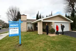 A "for sale" sign hangs outside of a home in Atlanta last month. The Atlanta market in particular has flooded with investors looking for properties to turn into rentals.