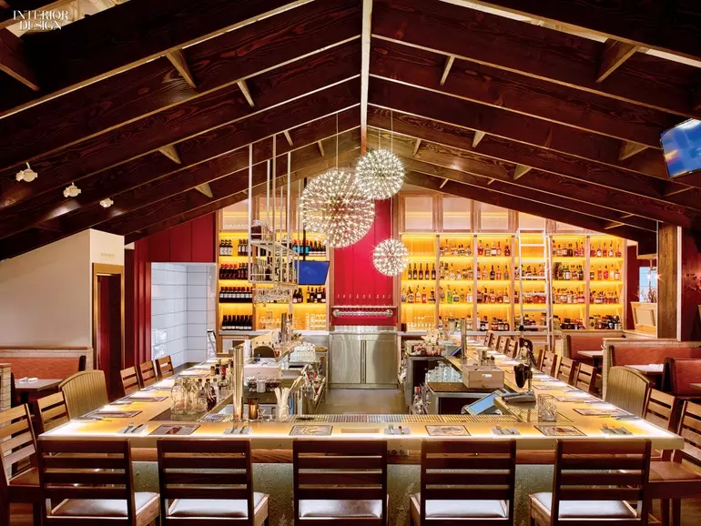 With seating on all sides, this bar beneath a pitched roof invites diners to connect.