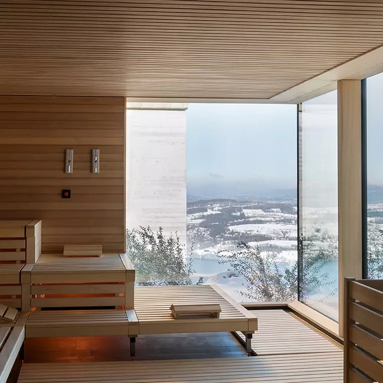 The architecture and design of this spa includes tiled walls that meld with natural wood accents