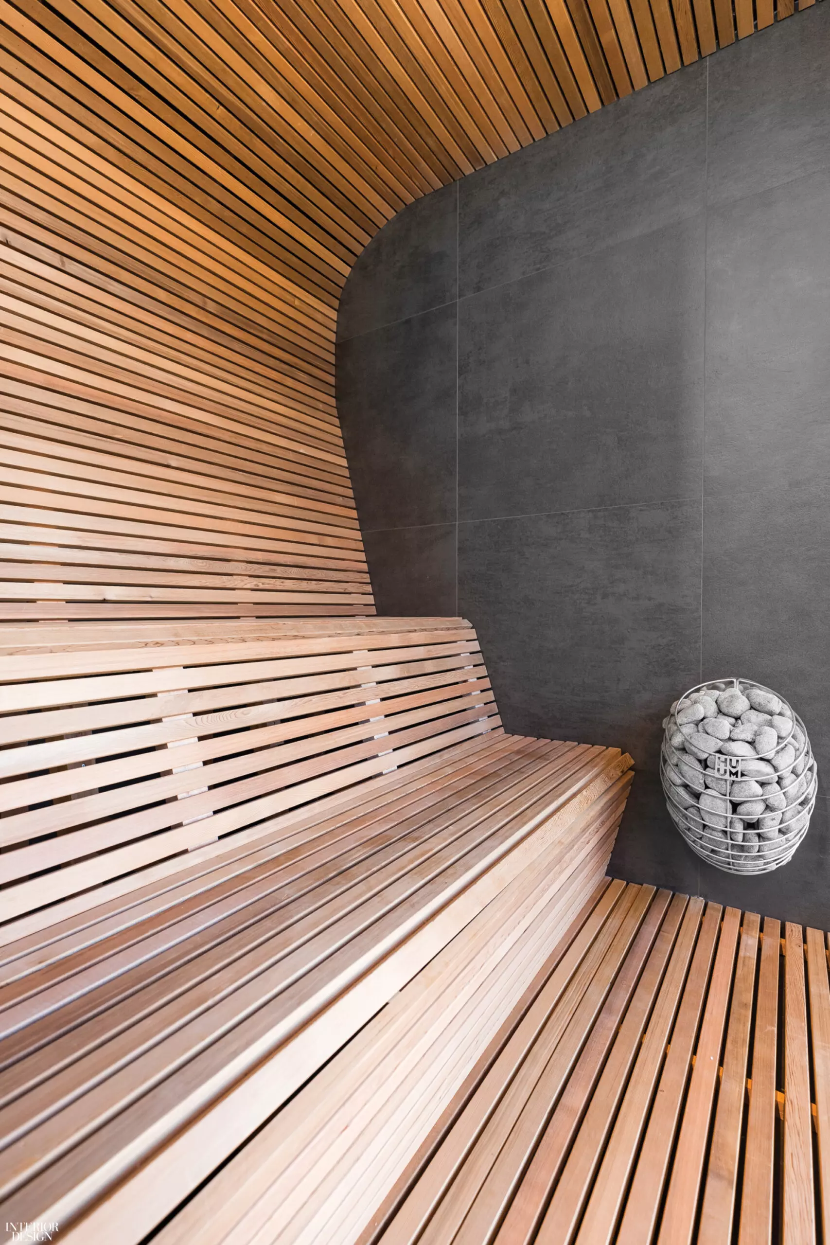 Wooden slats snake around the wall, providing space to sit in this spa design