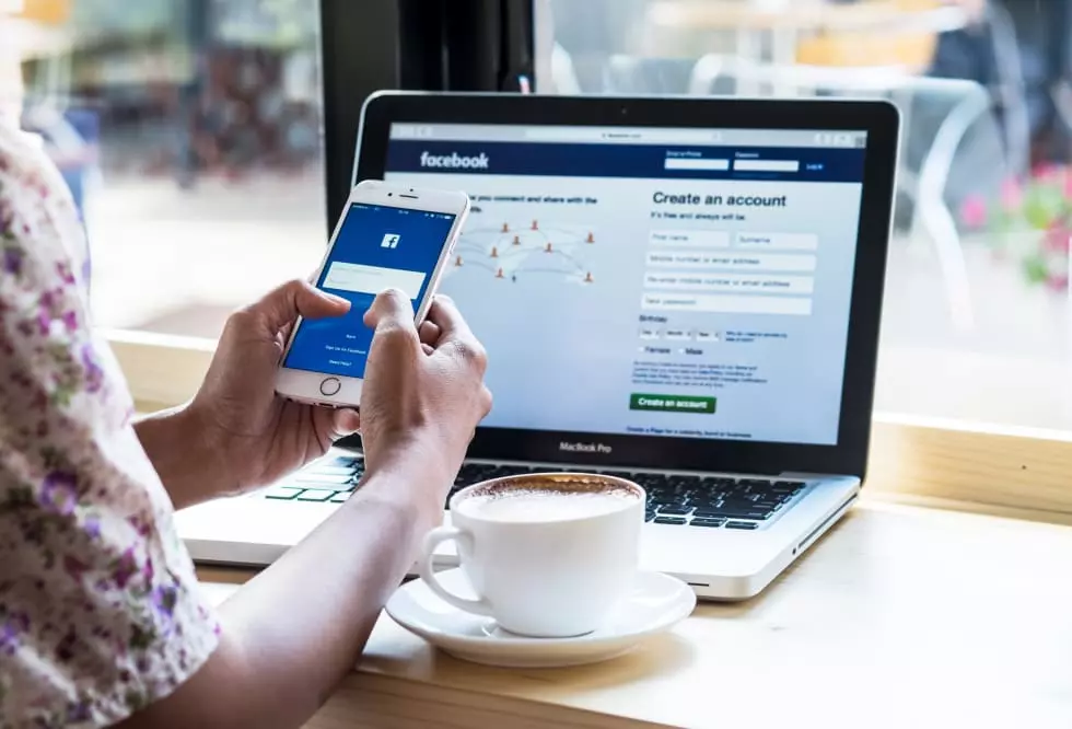 A women holds Apple iPhone 6S with facebook application on the screen. Facebook is a photo-sharing app for smartphones.