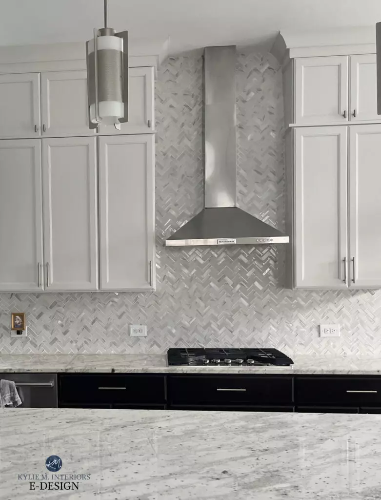 Granite countertop in kitchen with Sherwin Williams Drift of Mist painted cabinets, mosaic tile backsplash, stainless steel