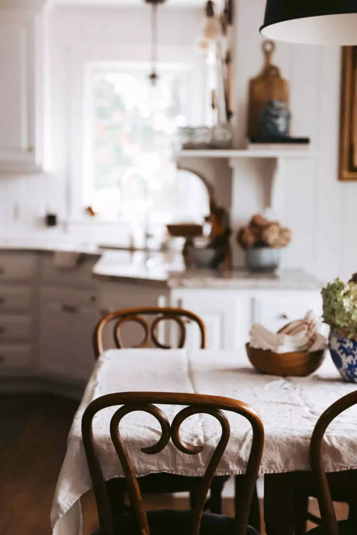 table in a kitchen with wooden chairs