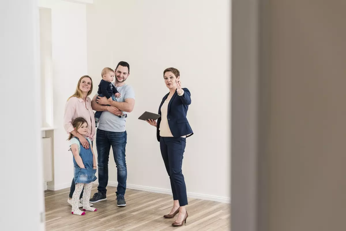 Property manager showing young family a new apartment