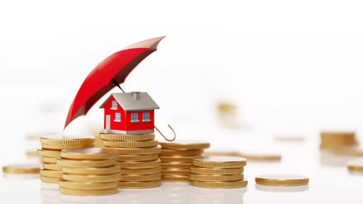 house covered by umbrella on coins