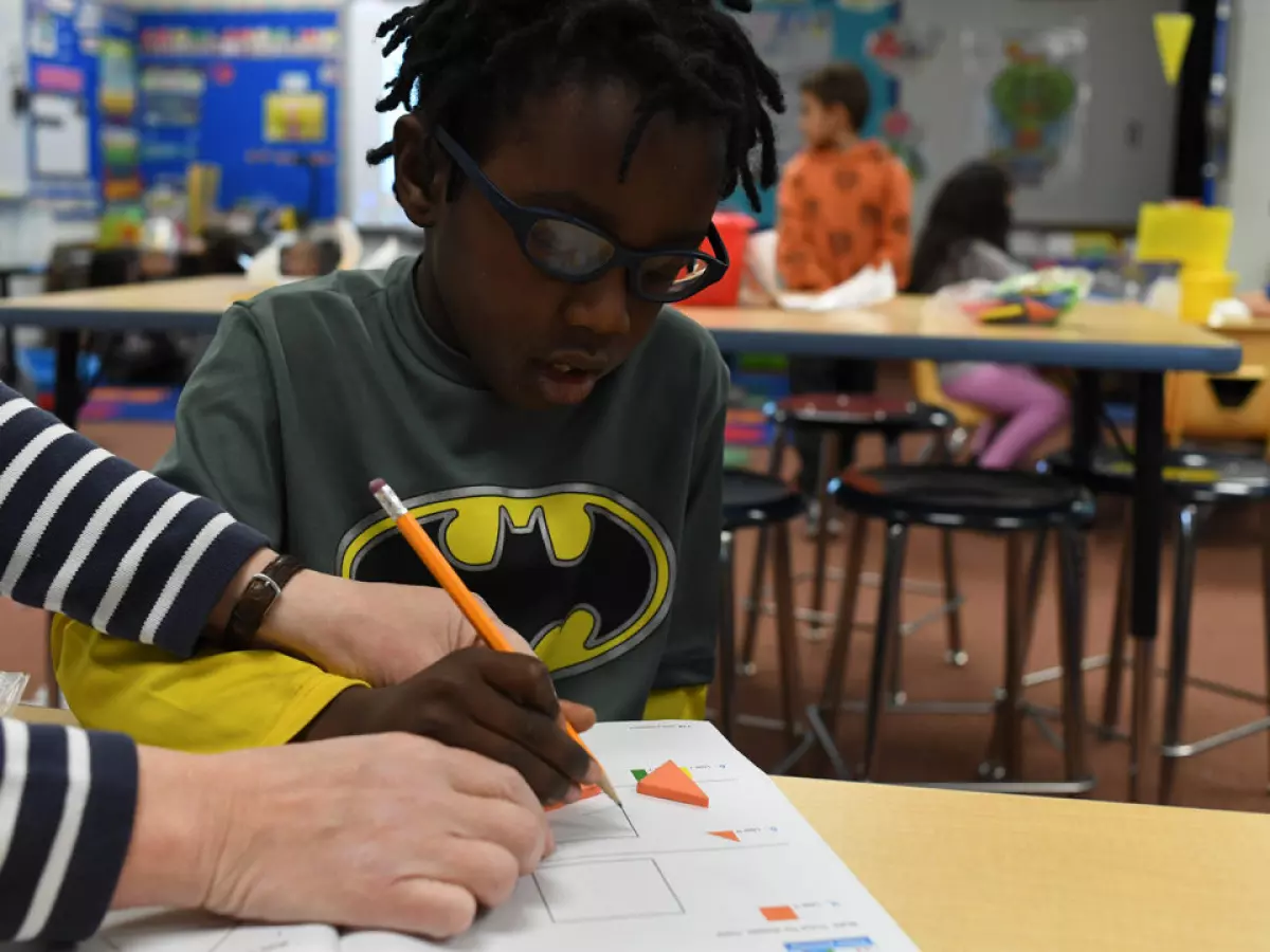 Tyree Howard, 5, gets help with his shapes during kindergarten class at Westgate Elementary School in Lakewood, Colorado.