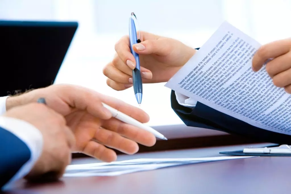 two people reviewing real estate documents