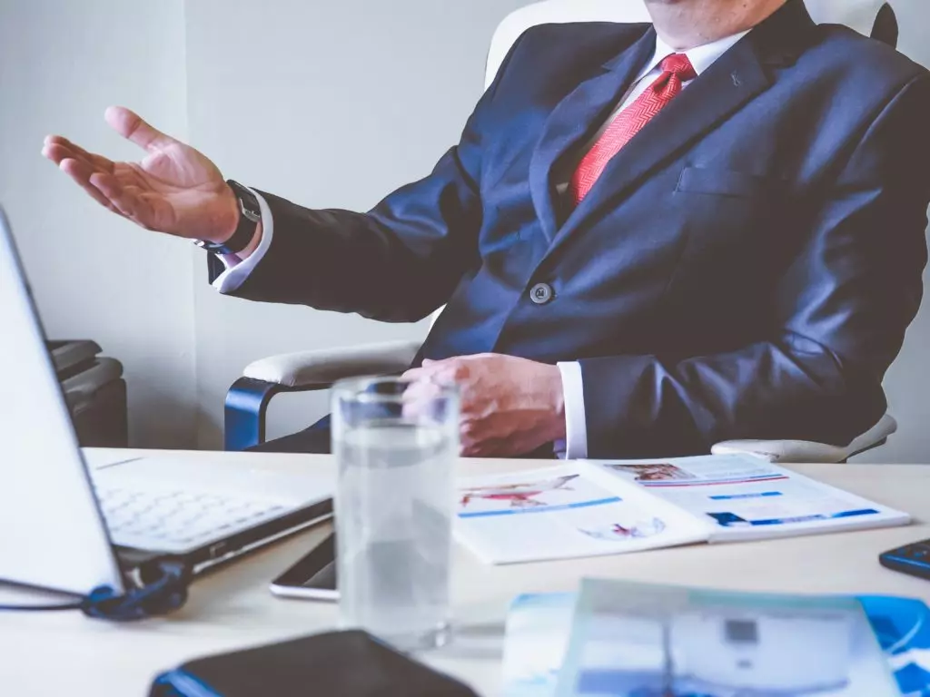 Man at office desk discussing business