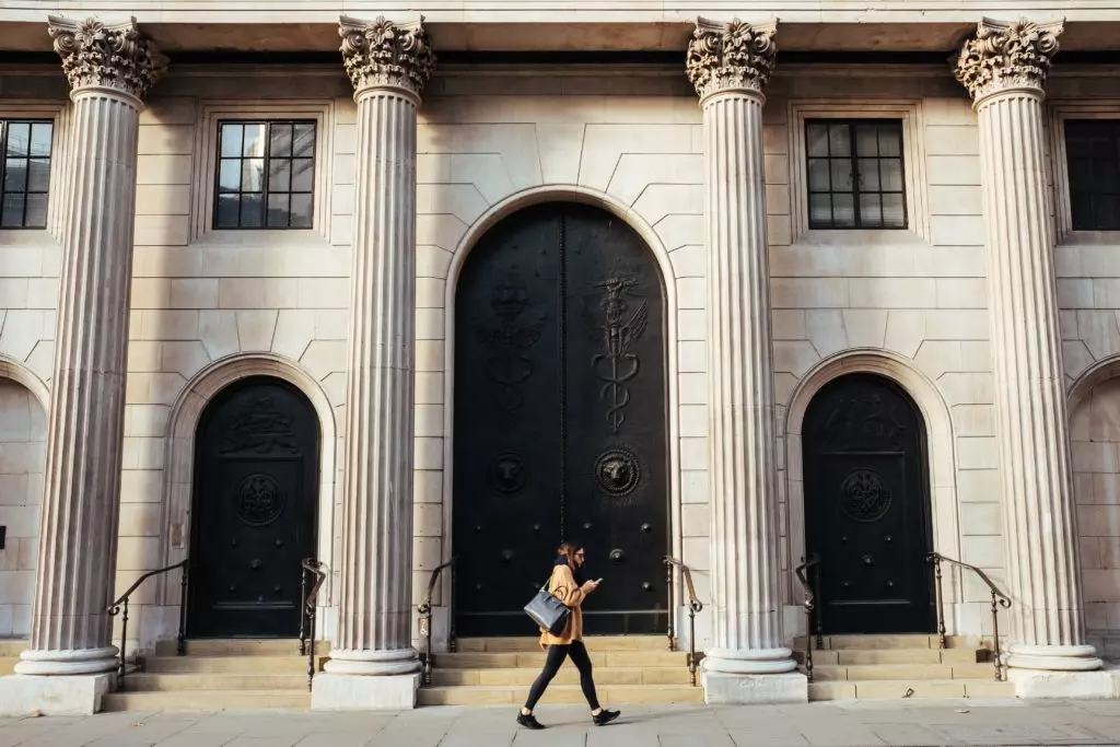 woman walking in front of bank