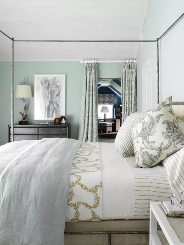 light grey bedroom with navy pillows and blanket