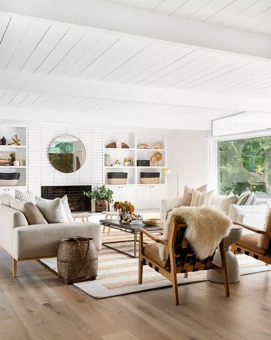 A beautiful modern living room with cozy curved chairs and a slipcovered sofa