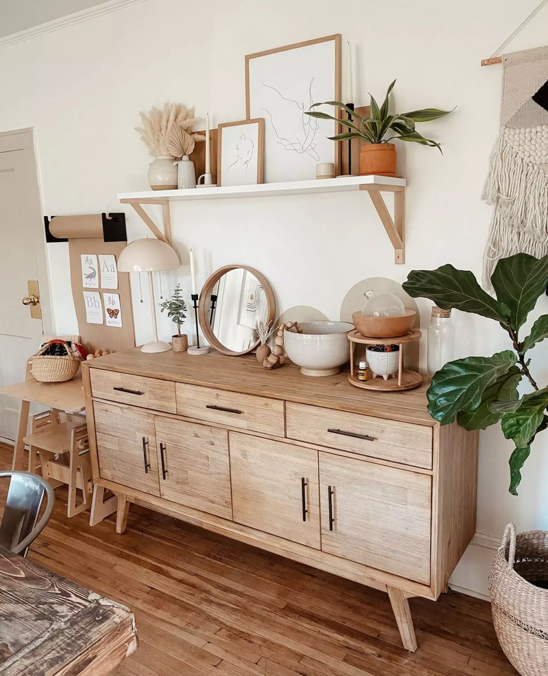 A rustic wooden sideboard adorned with decorative items and plants.