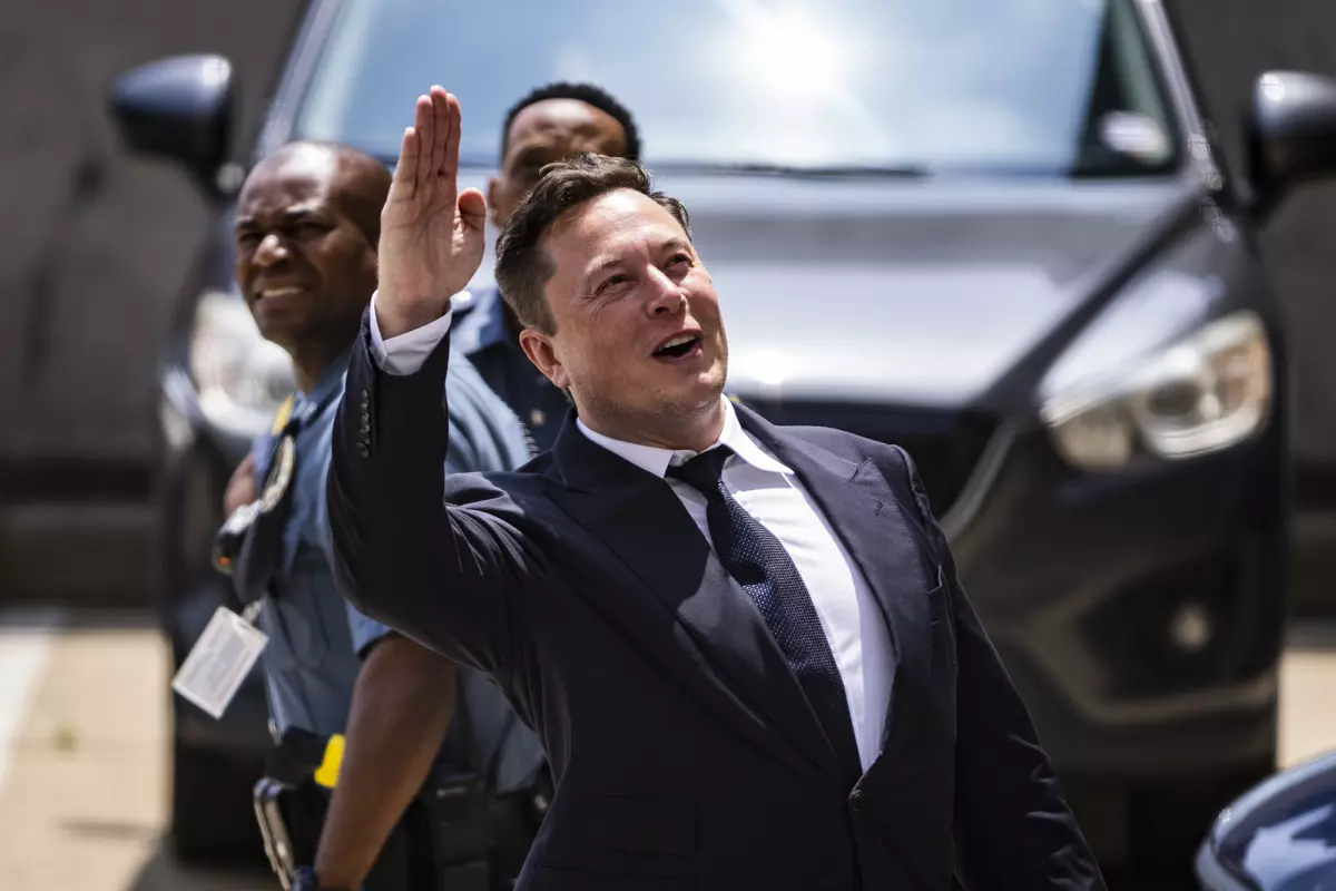 Elon Musk, chief executive officer of Tesla Inc., waves while departing court during the SolarCity trial in Wilmington, Delaware, U.S., on Tuesday, July 13, 2021. Musk was cool but combative as he testified in a Delaware courtroom thatTesla