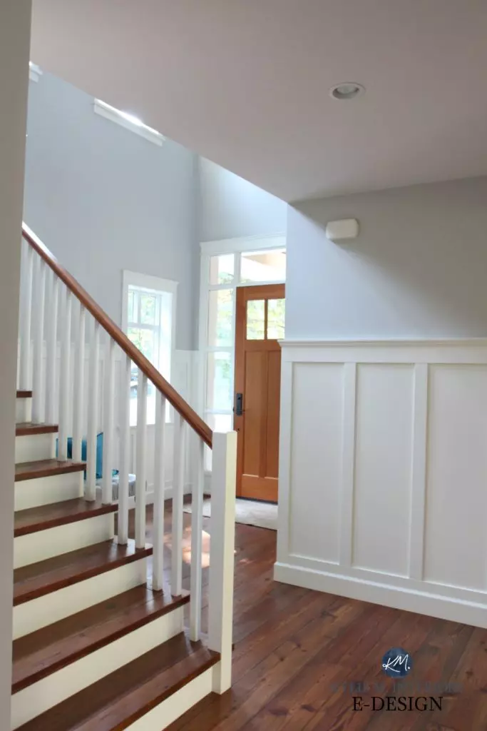 Entryway in Sherwin Williams Colonnade Gray with an oversized large clock, charcoal bench seat, and foyer front door painted Urbane Bronze. Kylie M Interiors Edesign, online paint color expert