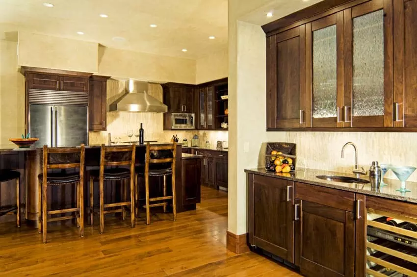 White high chairs, wood countertop and hanging lights