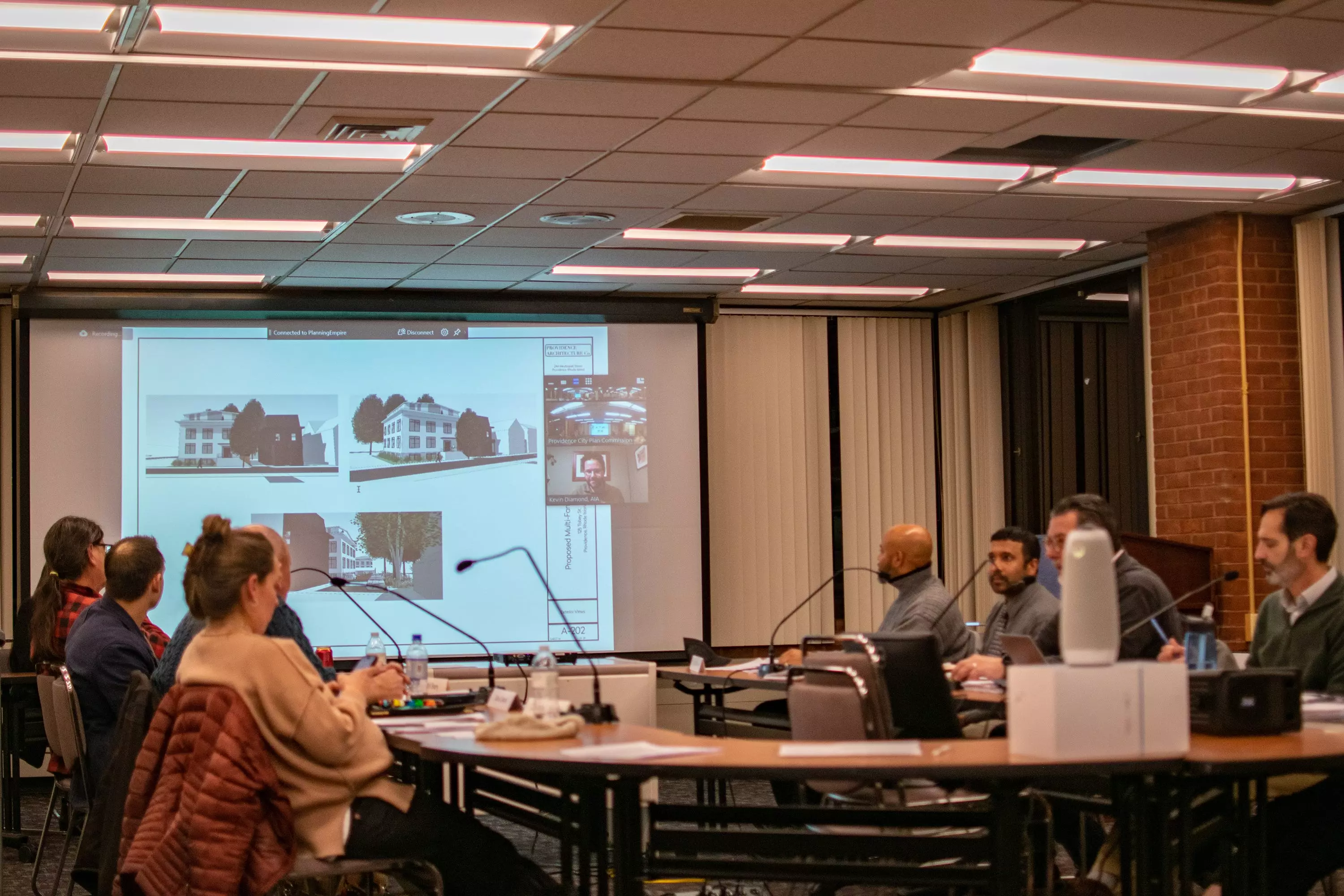 These renderings show a low-slung building proposed at an empty lot at 125 Tobey Street