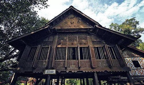 A typical window of a Malay house with slanted wooden panels that can be adjusted for ventilation.