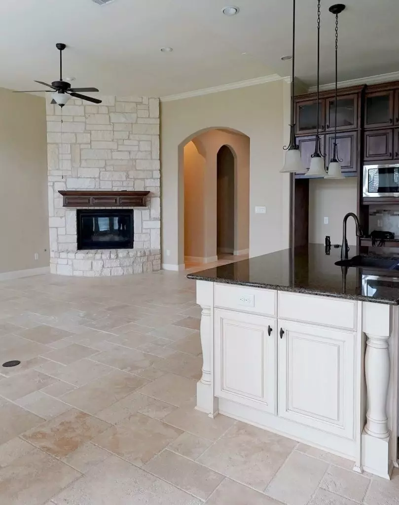 Sherwin Williams Antique White with travertine floor and beige walls and stone fireplace. Kylie M Interiors Edesign, online paint color consultant