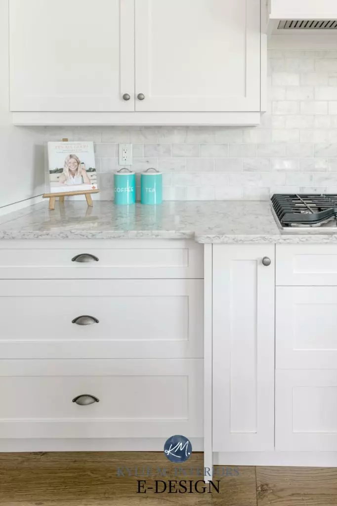 Kitchen cabinets painted Sherwin High Reflective White, marble backsplash, white quartz, home decor on countertop. Pewter hardware. Kylie M Interiors Edesign, online paint colour consulting