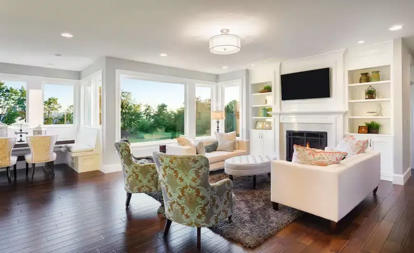 Living room with transitional furniture, coffee table, rug, fireplace, shiplap ceiling, chairs, rug, and windows