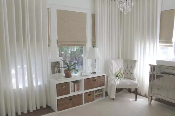 a blue, white, and gold color scheme in the bedroom can feel ultra-luxurious with roman shades and curtains