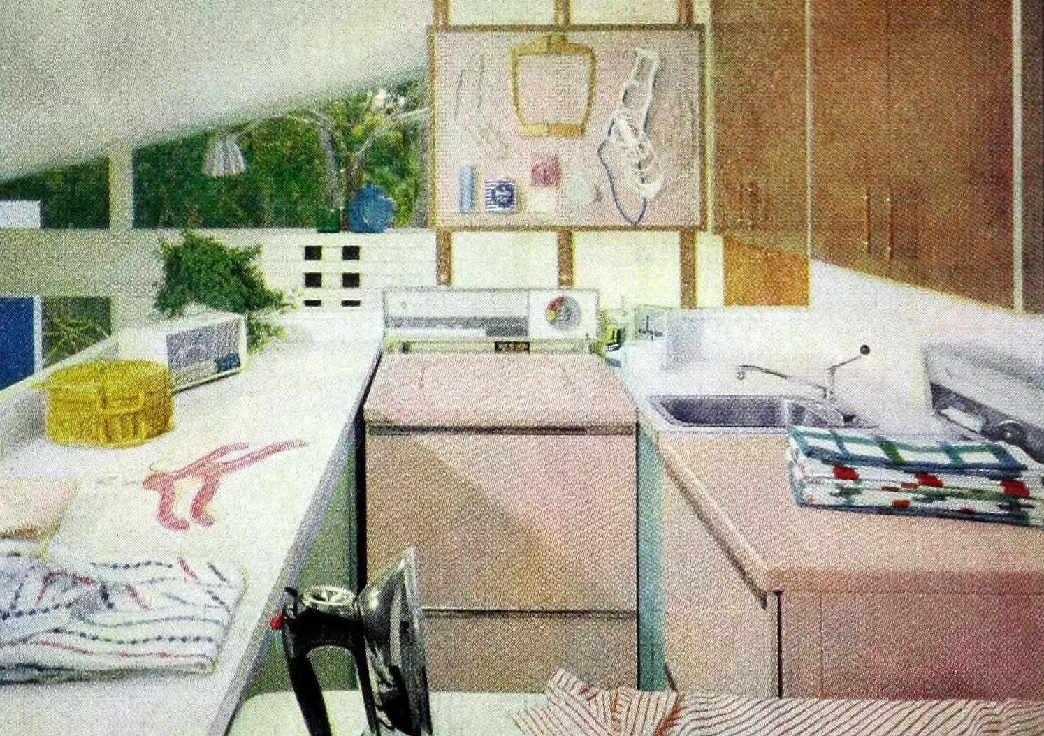 Vintage pink laundry room with sink, counter space, and ironing board (1959)