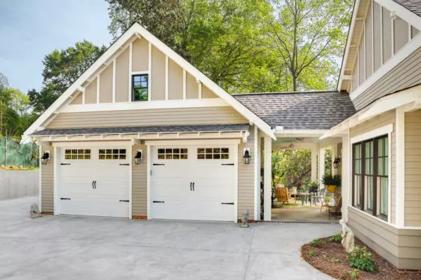 go back in time with a stunning stone build featuring a detached garage and breezeway with fairy lights