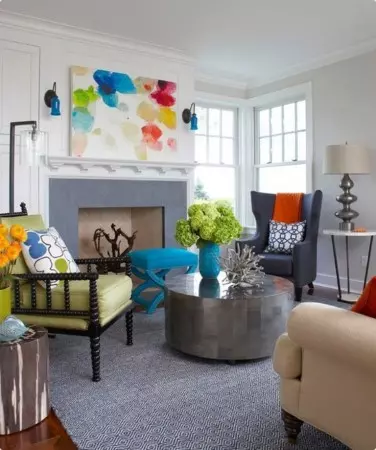 A funky purple couch in a cool living room.