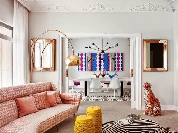 A living room with funky zebra print furniture and cool zebra rugs.