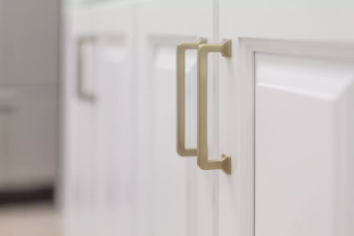 white cabinet with gold handles