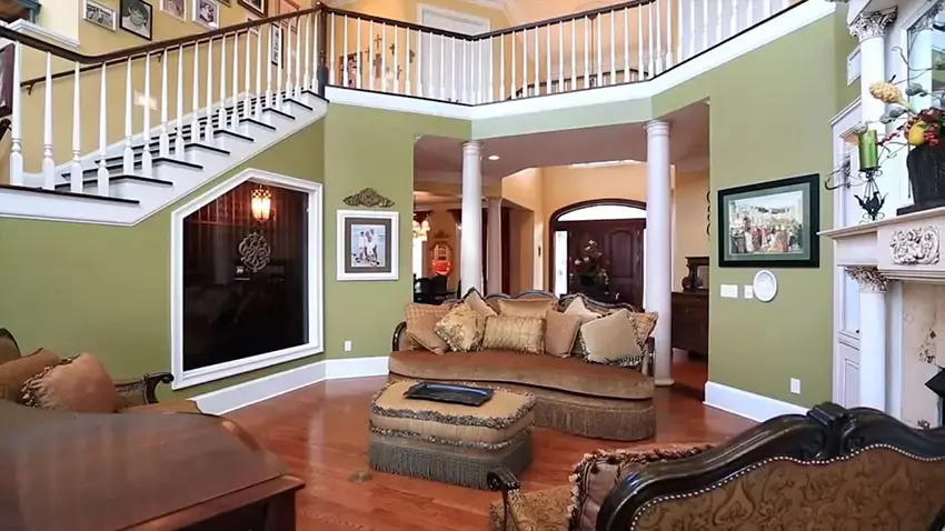 Master bedroom with wood floors crown molding fireplace and tray ceiling