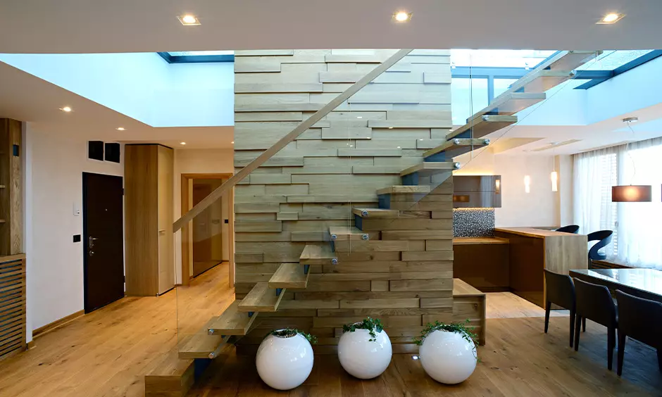 A gorgeous contemporary staircase design with a bookshelf