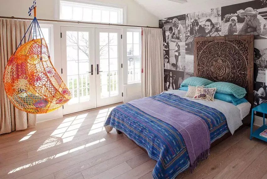 Contemporary bedroom with swinging rattan chair and bed with storage underneath