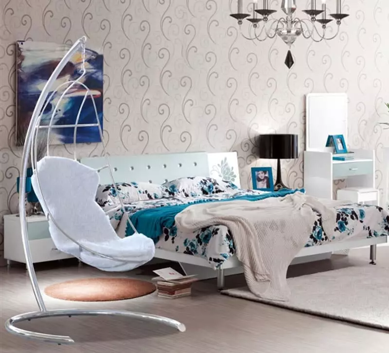 Pretty girls bedroom with aqua color hanging chair and feather chandelier