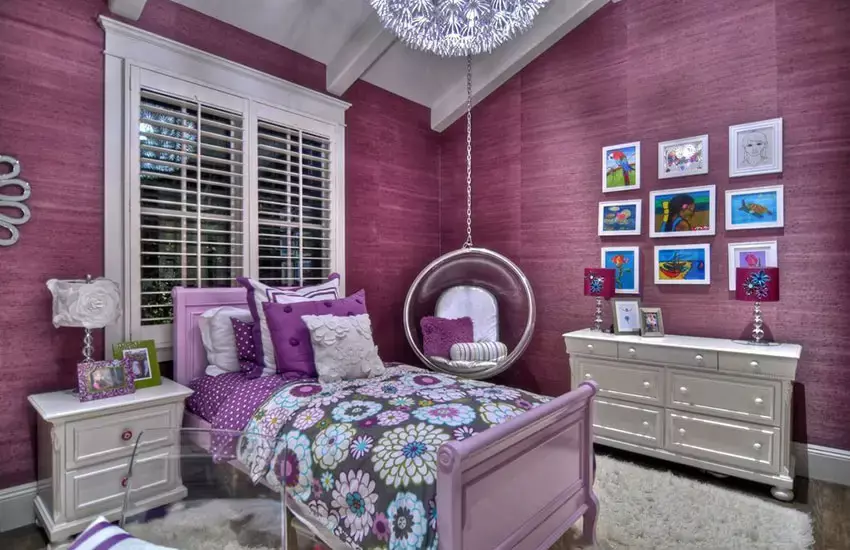 Bedroom with bird's nest hanging wicker chair and outdoor views