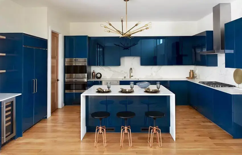 Kitchen with glossy blue cupboards and bright brass finish