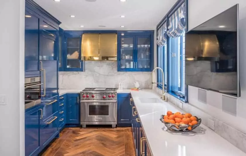 Kitchen with beadboard cabinets and blue vintage appliances