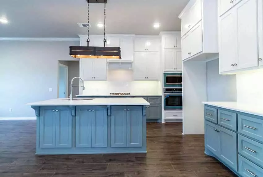 Galley kitchen with counters in blue with legs under cabinets