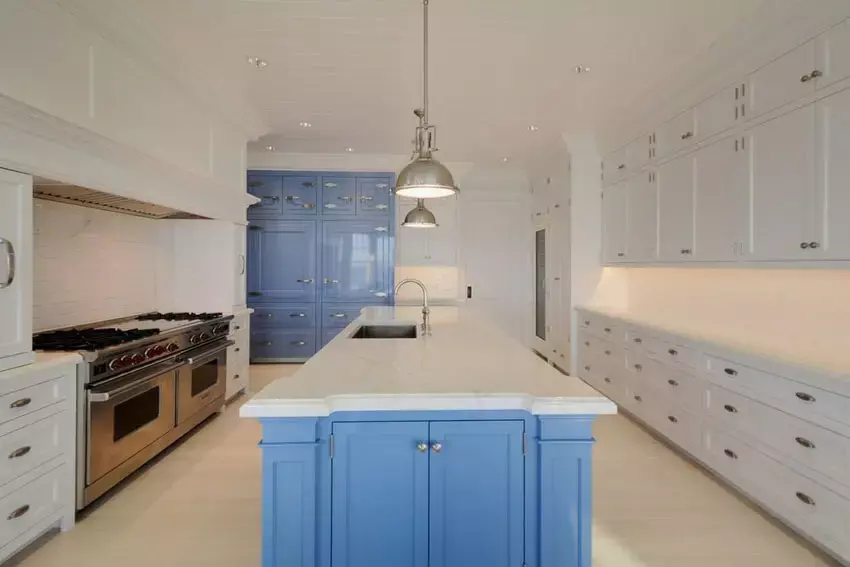 Kitchen with cobalt blue walls, concrete counters, and a baseboard